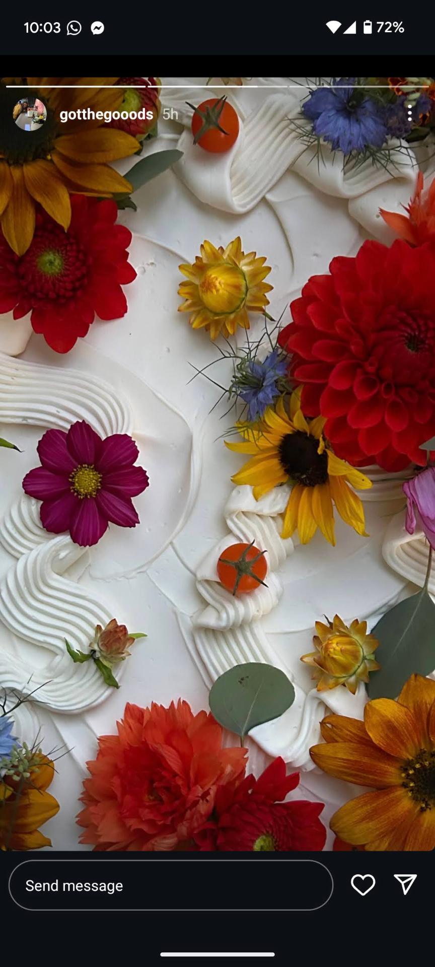 Close-up of a buttercream cake topped with sunflowers, dahlias and edible blooms